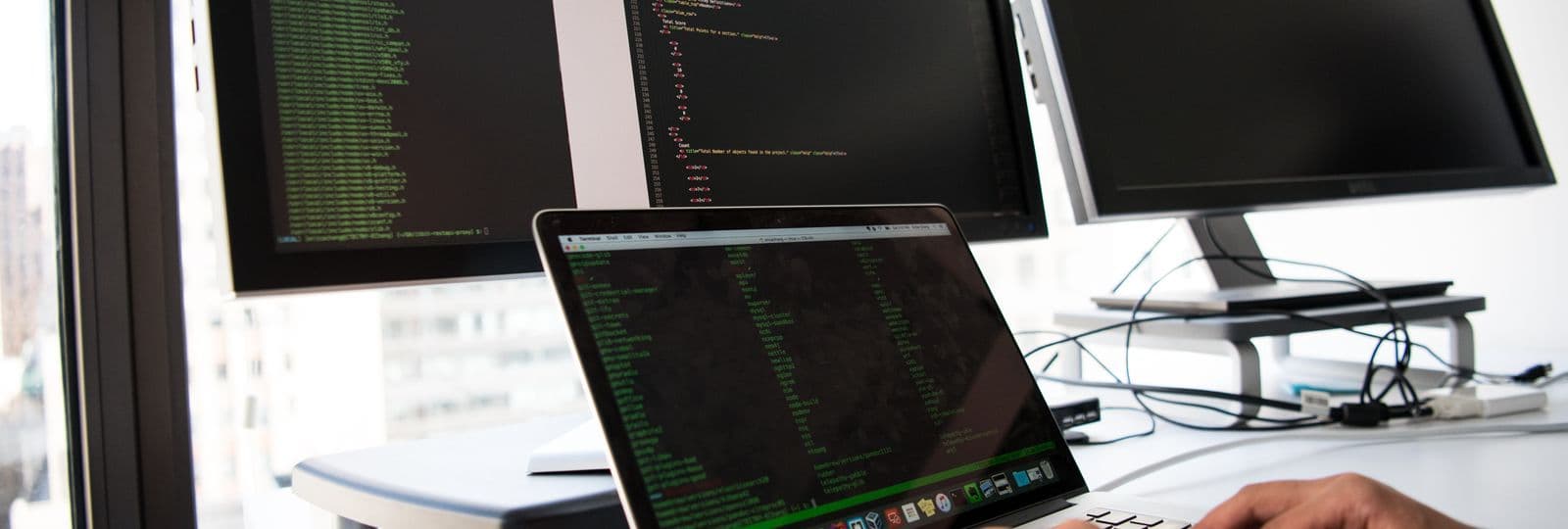 A security operator testing systems across multiple screens